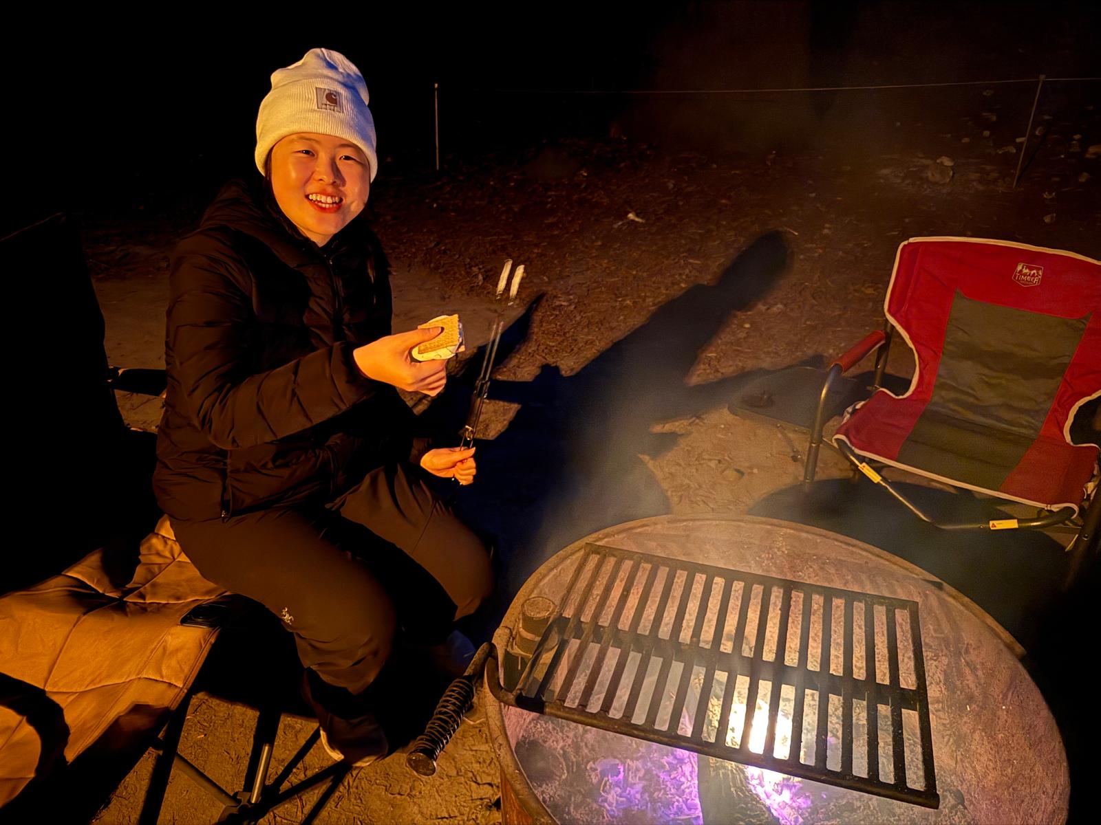 Jiali camping by a fire in Big Sur